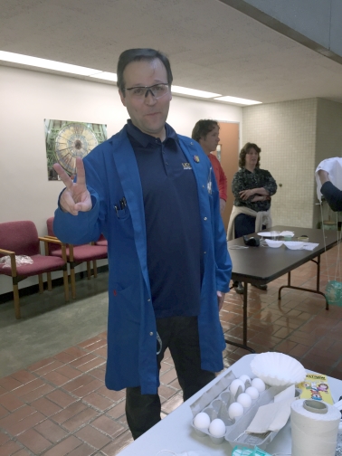 Matthew Smith is pictured in a blue coat, holding up a peace sign.