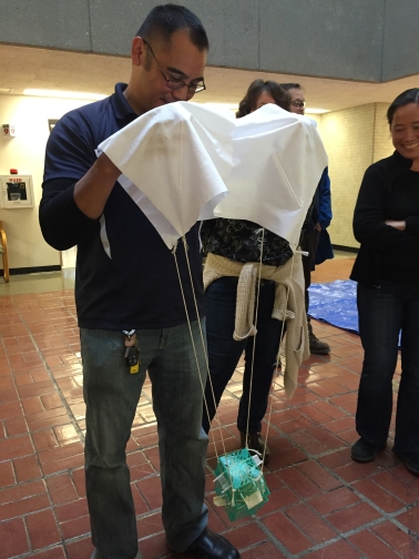 Sison stands with the egg drop creation in hand.