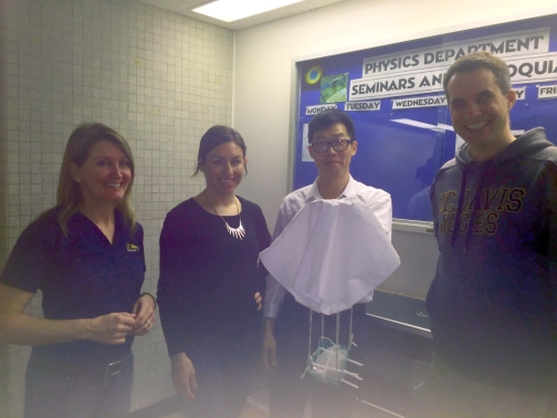 Team 2 members Lade, Vasquez, Wang, and Tuck pose for a photo in front of their egg drop contraption.