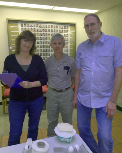 Team 3 members Brooks, Barnett, and DeLong pose for a photo in front of their egg drop contraption.