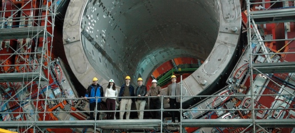 Scientists in front of the CMS detector