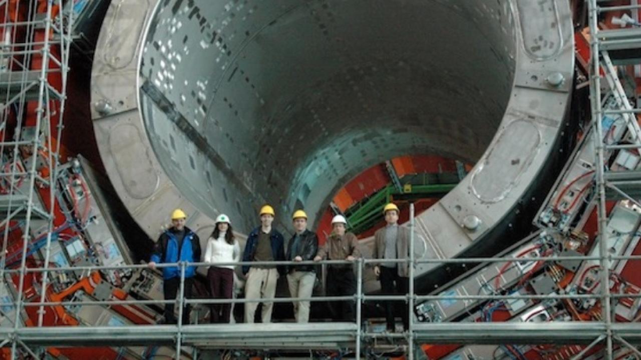 Scientists in front of the CMS detector