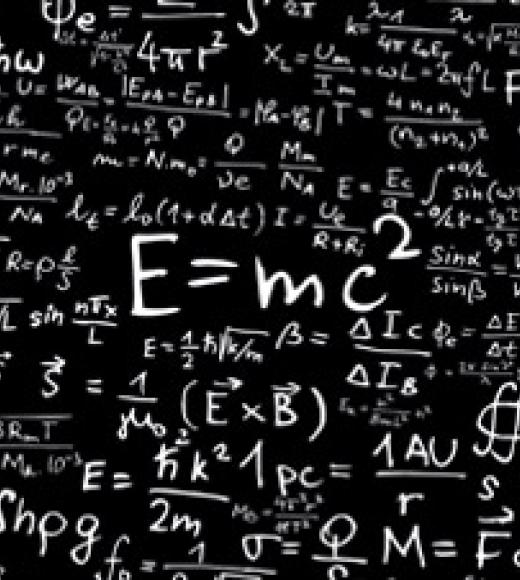 A chalkboard filled with various scientific equations, prominently featuring E=mc².